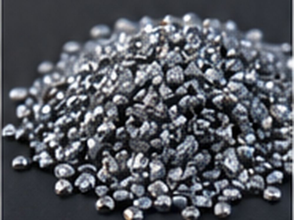 Close-up pile of small metallic silicon granules for material processing.