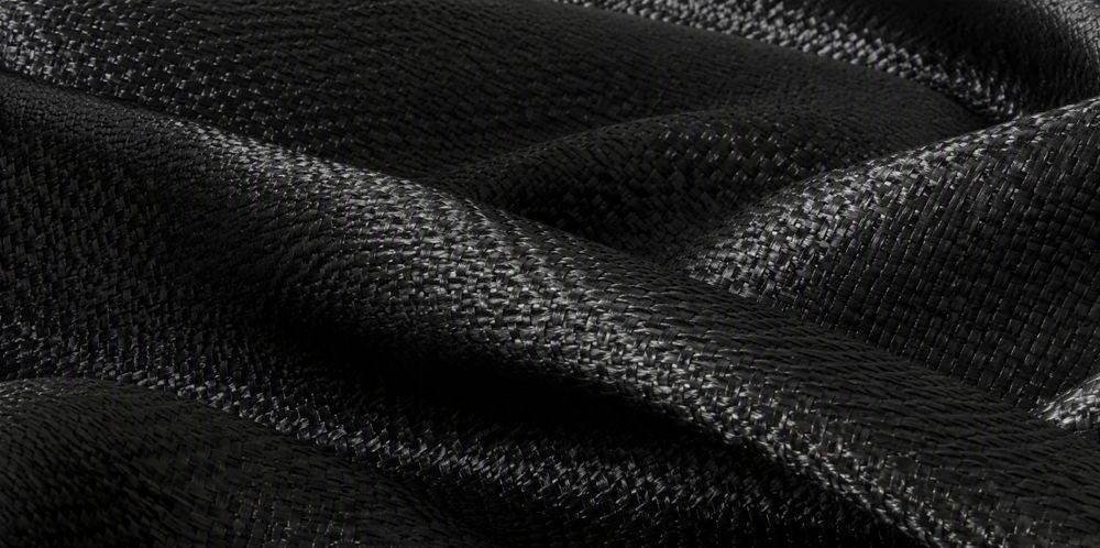 Woven silicon carbide fiber fabric draped in soft folds showing a fine weave texture.