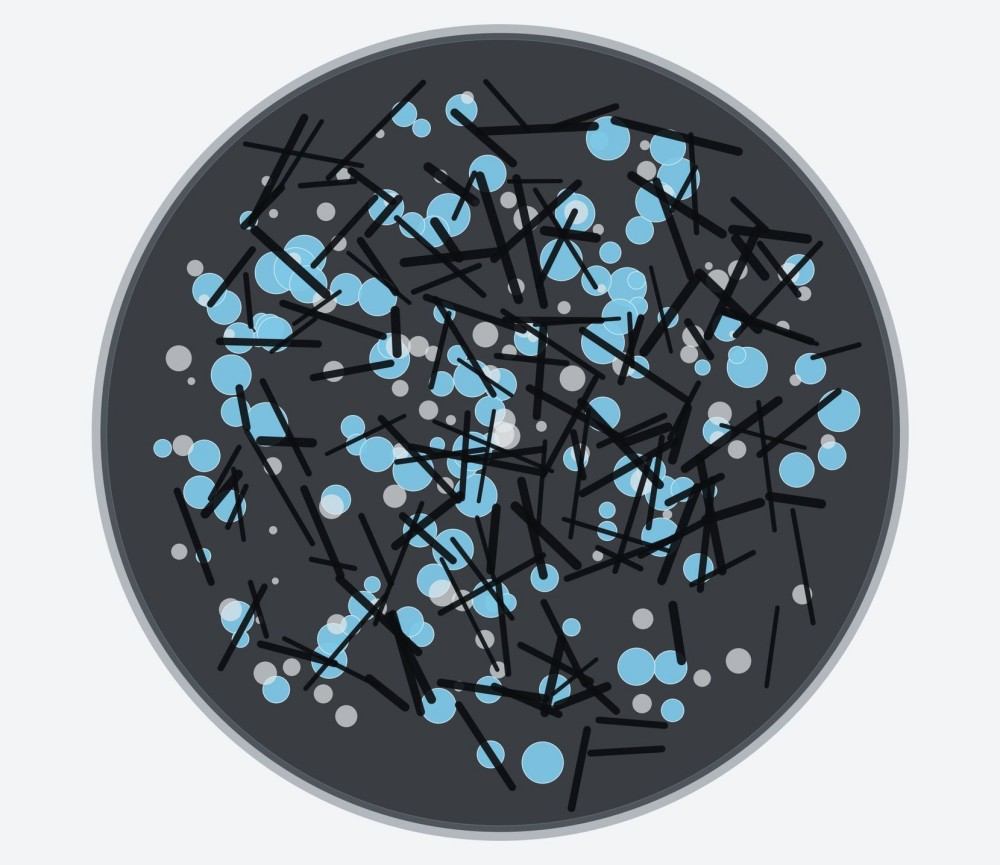 Cross-section of a spherical silicon–graphite composite particle containing distributed nanosilicon and conductive carbon.