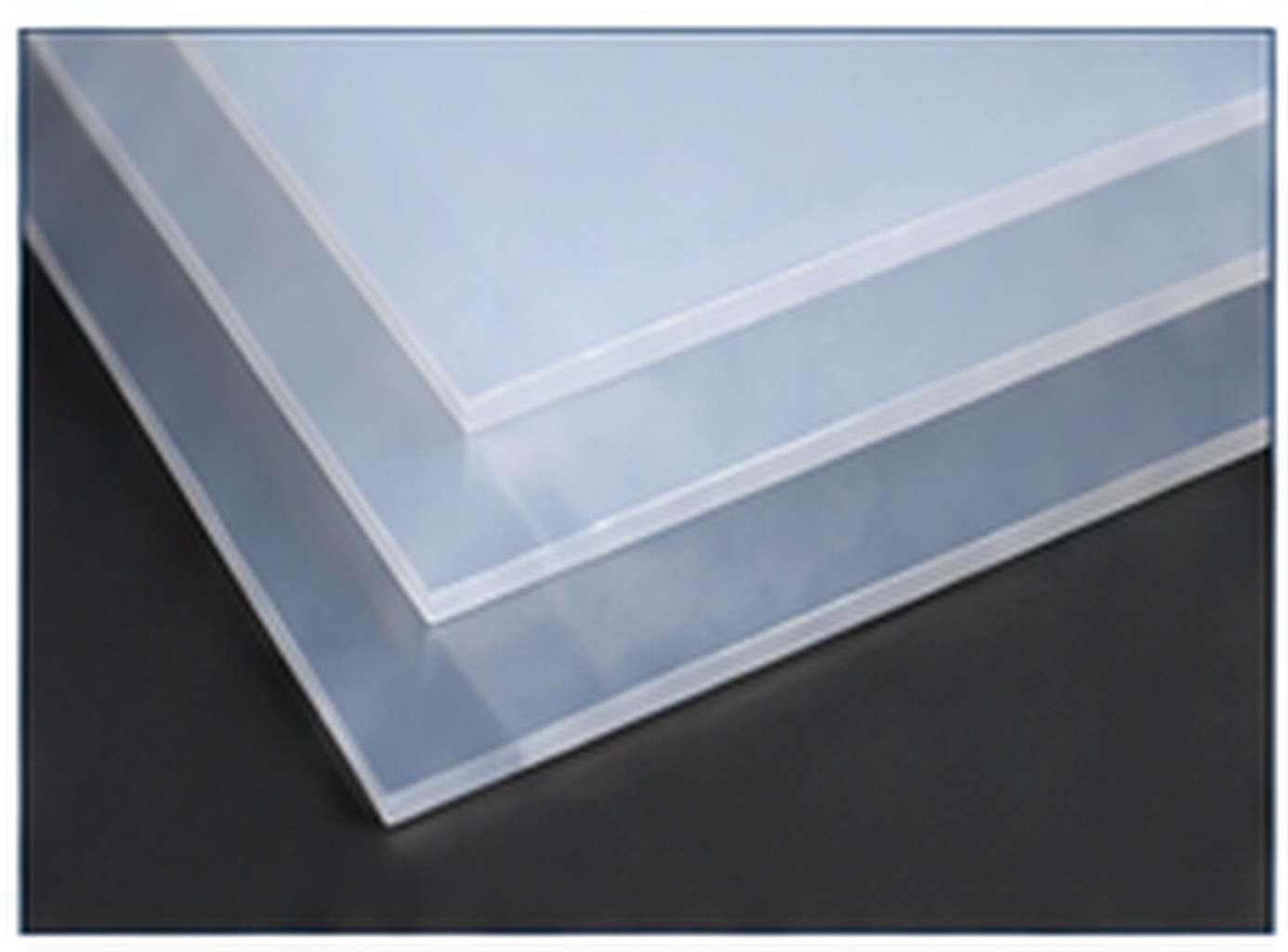 Stacked translucent silicone rubber sheets with clean squared edges.