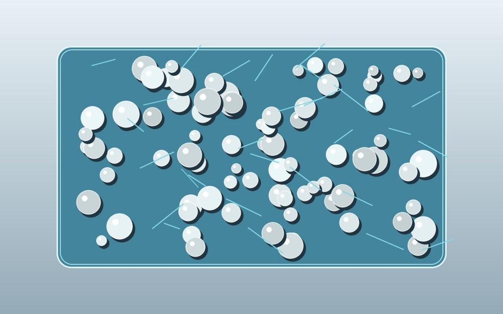 Spherical ceramic fillers are evenly embedded inside a clear silicone-modified epoxy matrix.