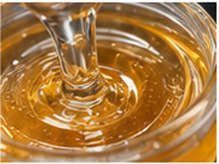 Amber silicone resin formulation flowing in a vessel for custom materials development.