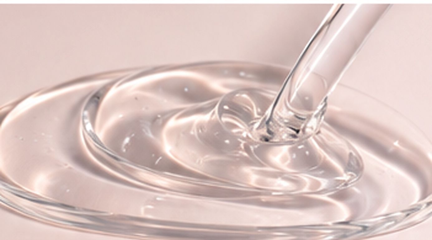 Clear silicone resin liquid spreading in a shallow dish for film-forming formulation studies.