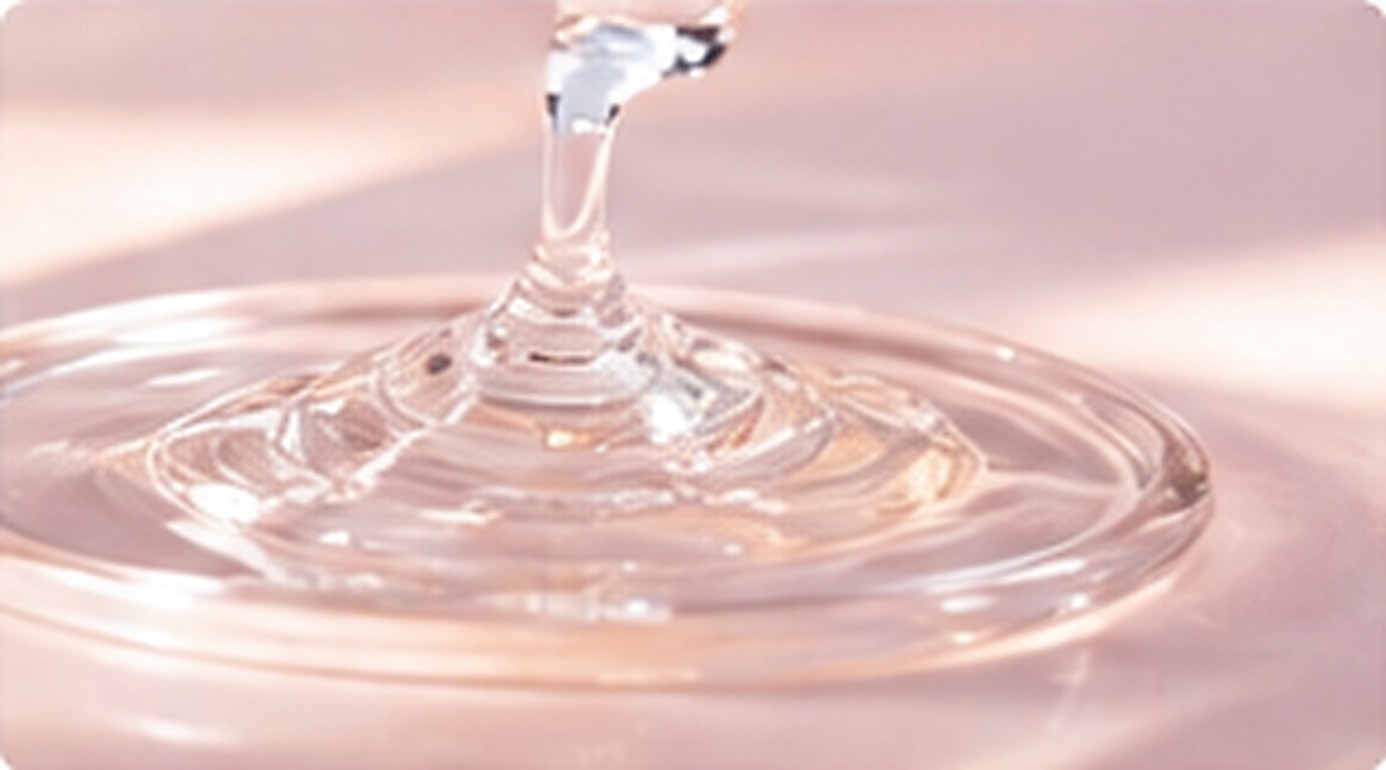 Transparent silicone resin blend forming a smooth glossy stream across a clear surface.