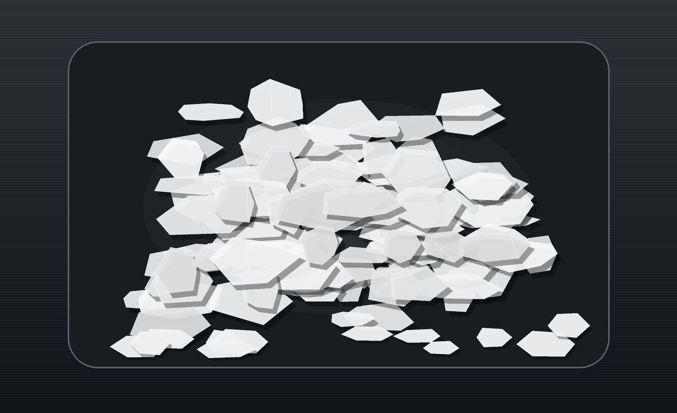 Crisp white silicone wax flakes arranged on a dark industrial tray.