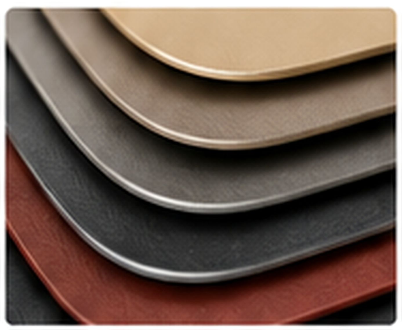Stacked leather-like sheets with matte finishes and varied soft-touch textures.