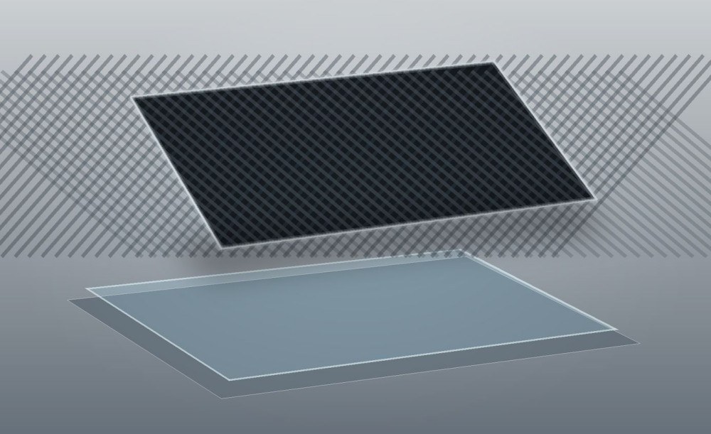 Carbon-fiber composite panel lifted from a smooth mold with a clear release interface visible beneath it.