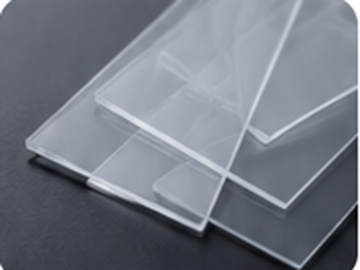 Stacked transparent substrate sheets representing coating compatibility and layered finish development.