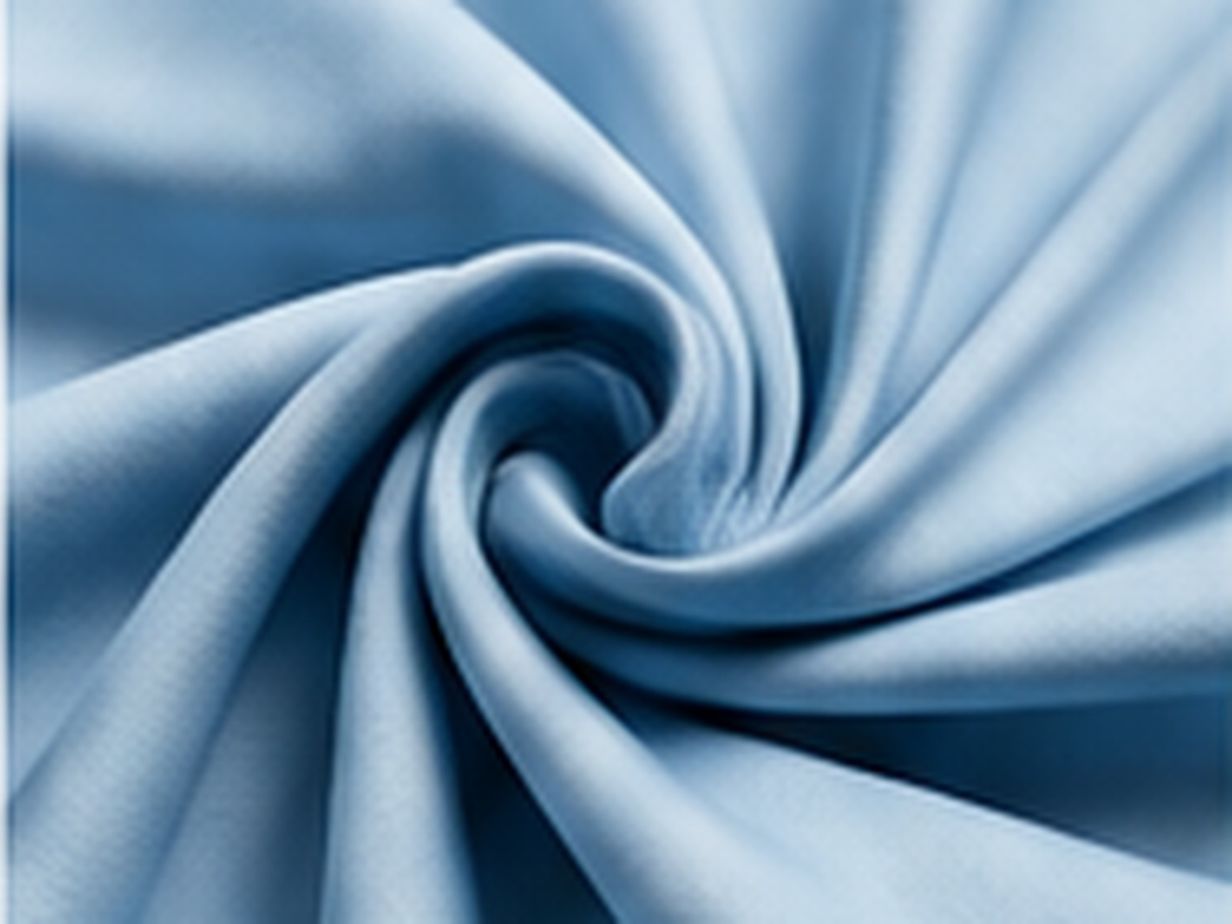 Close-up of pale blue draped textile showing a smooth low-friction surface finish.