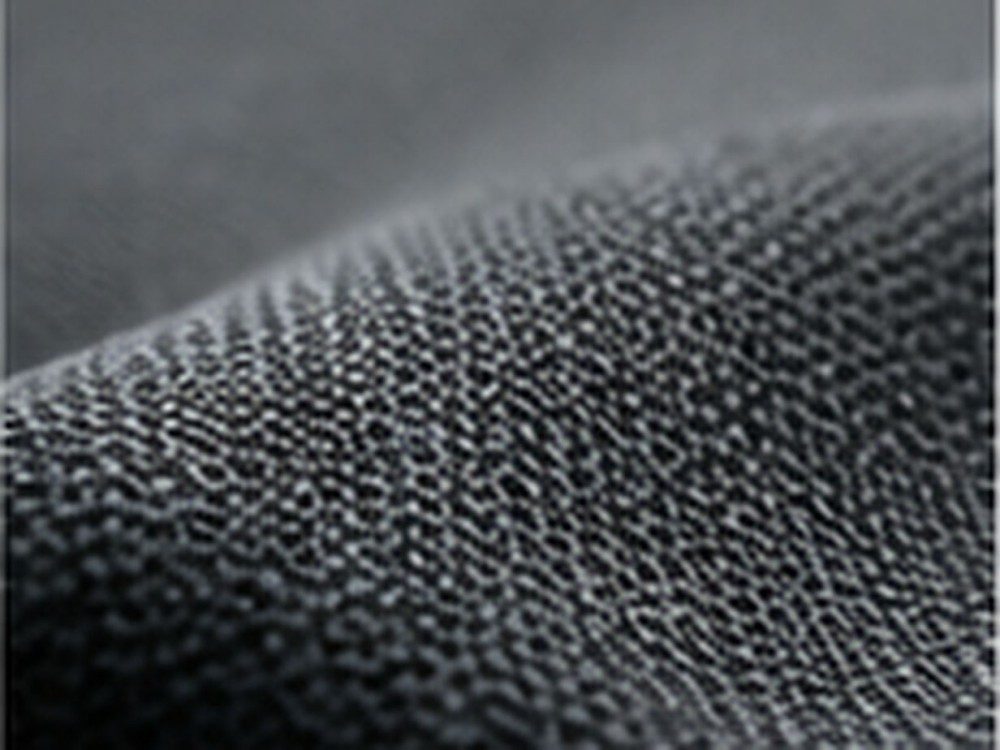 Close-up of dark gray densely woven fabric representing high-wear textile applications.
